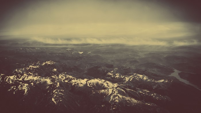 Aerial view of snow-capped mountains and clouds