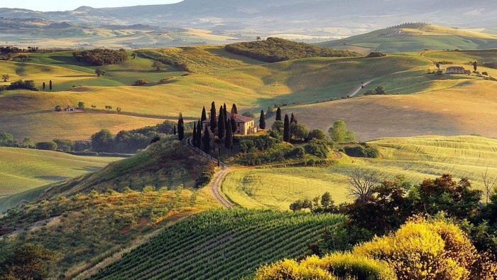 Tuscan landscape with rolling hills and a villa