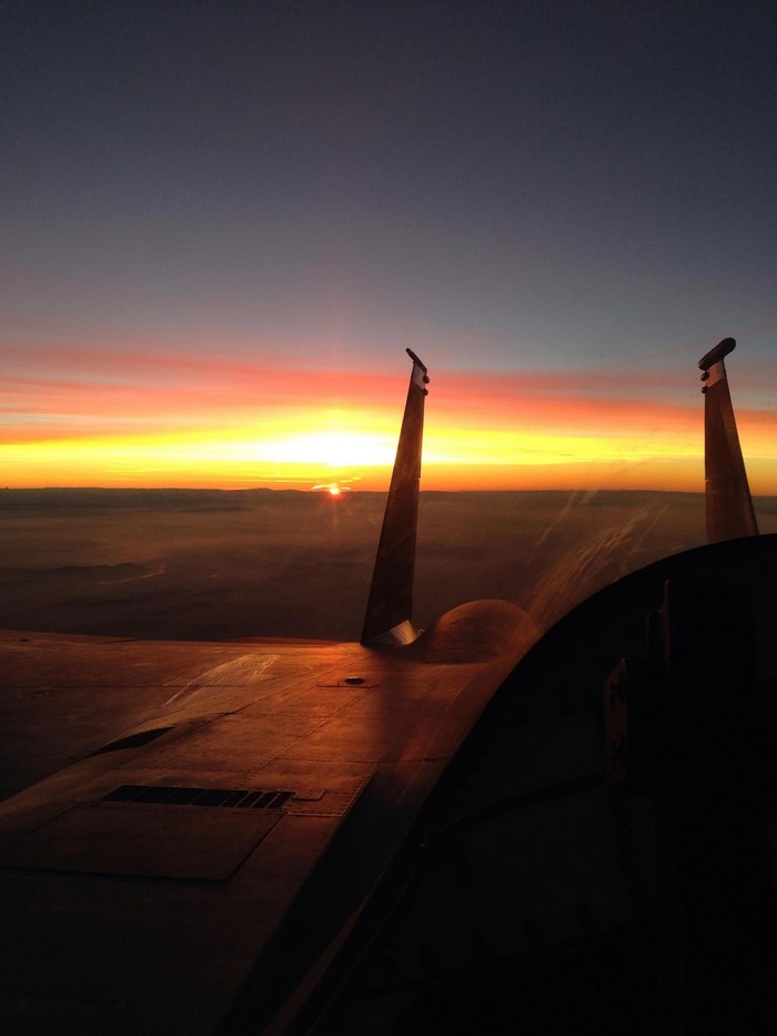 F/A-18 Hornet flying at sunset