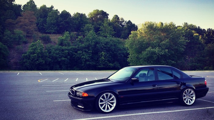 Black BMW 750iL E38 parked in a lot
