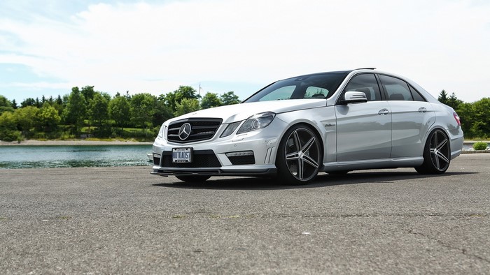 Silver Mercedes-Benz E63 AMG W212 parked by a lake