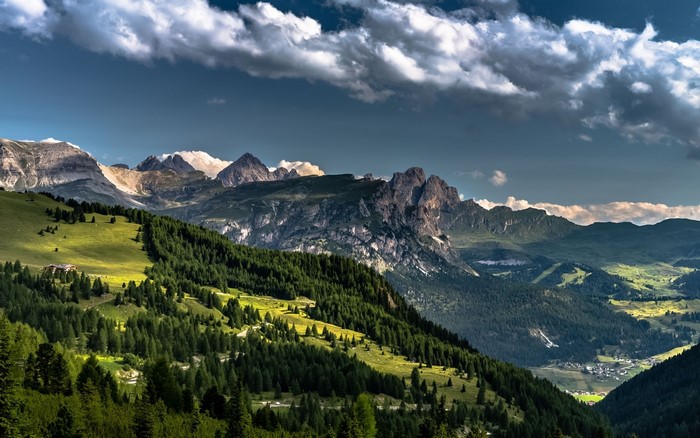 Dolomites mountains landscape with forest and village