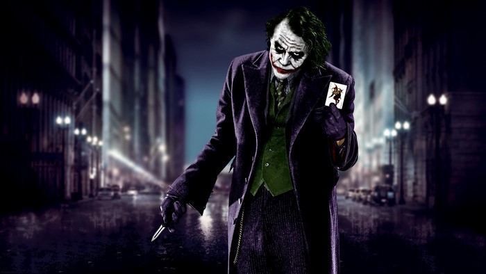 Joker with Card and Knife in Dark City