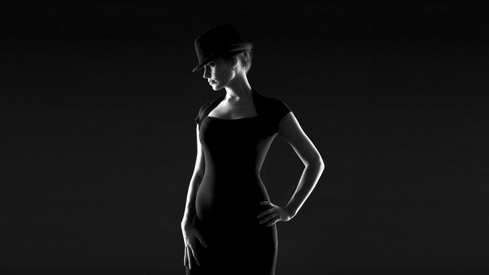 Woman in black dress and hat