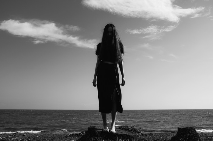 Monochrome silhouette of a woman on a beach
