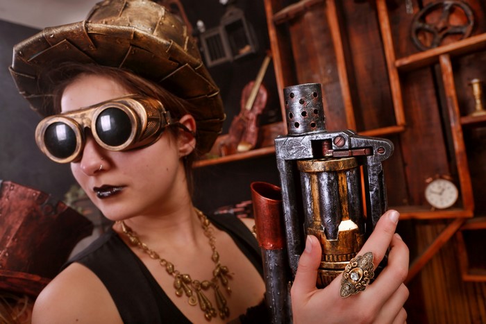 Steampunk woman with goggles and gun