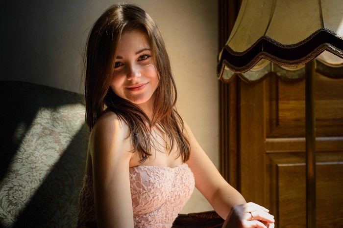 Woman with brown hair wearing a pink dress