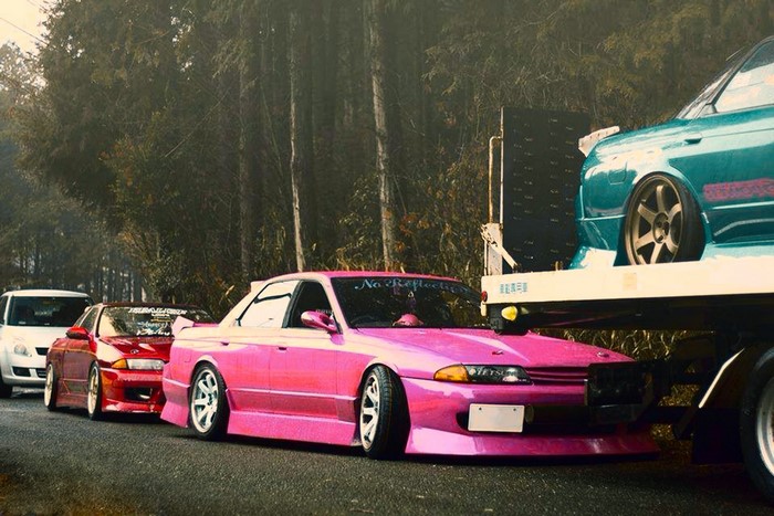 Nissan GT-R cars on a road in a forest