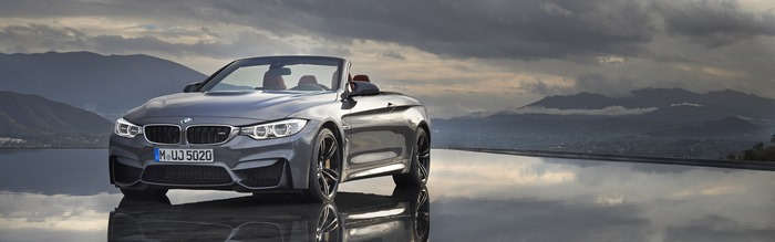 BMW M4 Convertible on reflective surface with mountains