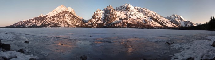 Snow-capped mountains over a frozen lake