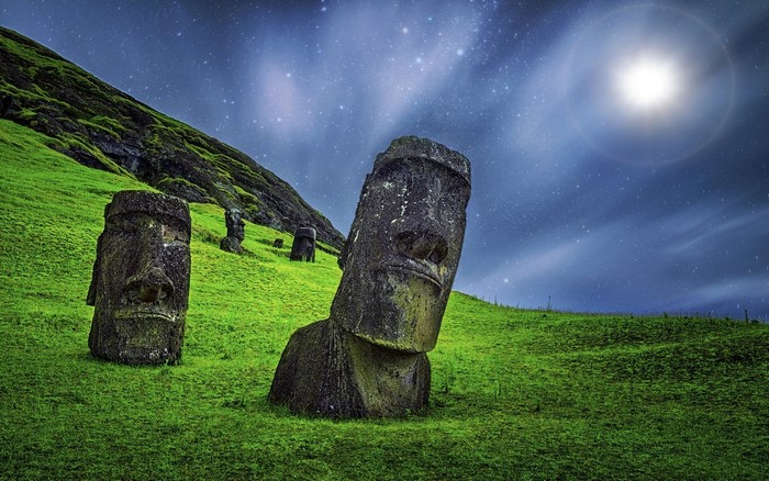Moai statues on Easter Island under a starry night sky