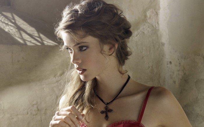 Julia Saner wearing lingerie and a cross necklace