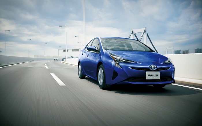 Blue Toyota Prius driving on a highway