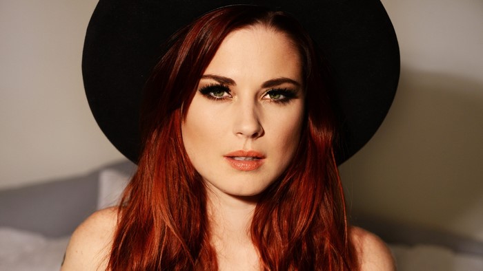 Alexandra Breckenridge wearing a black hat
