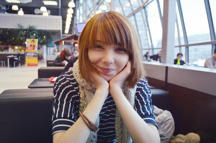 Woman with bangs and scarf smiling