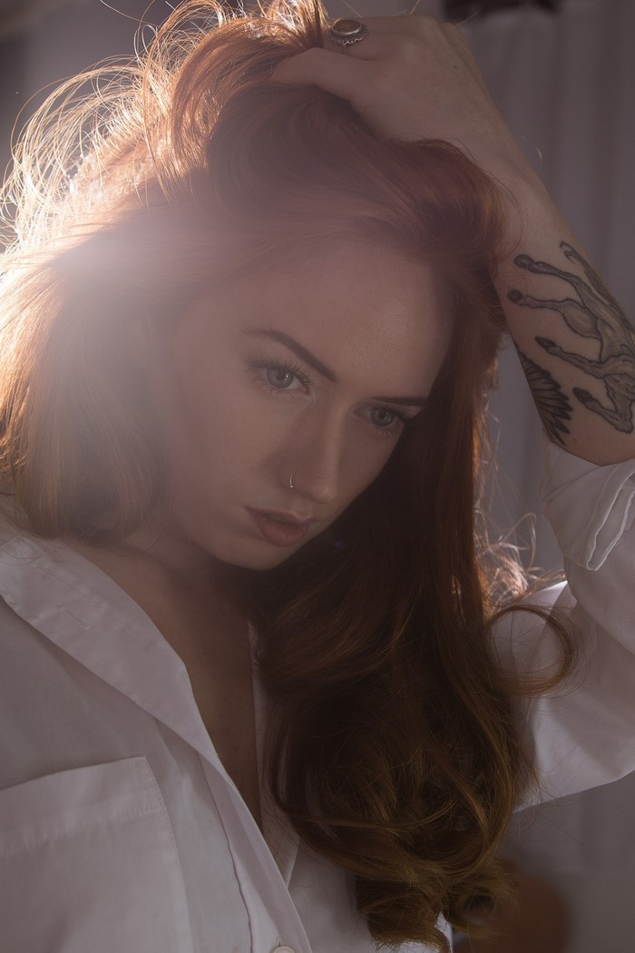 Redhead woman with tattoo and nose ring