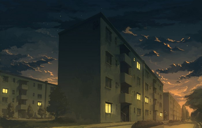 Apartment buildings at dusk with glowing windows