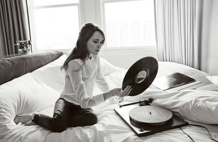 Ellen Page with vinyl record and gramophone on bed