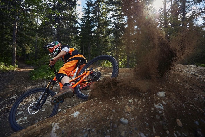Mountain biker riding downhill in a forest