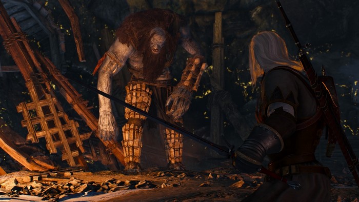 Geralt of Rivia fighting a giant in The Witcher 3