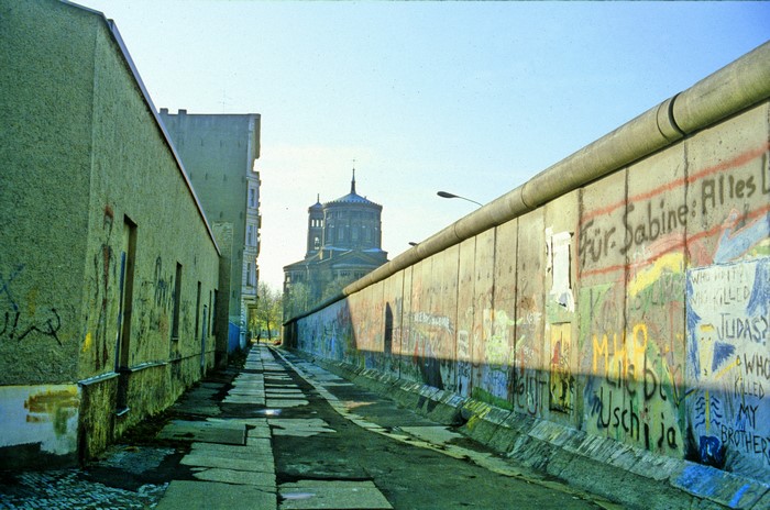 Berlin Wall with graffiti and church in background