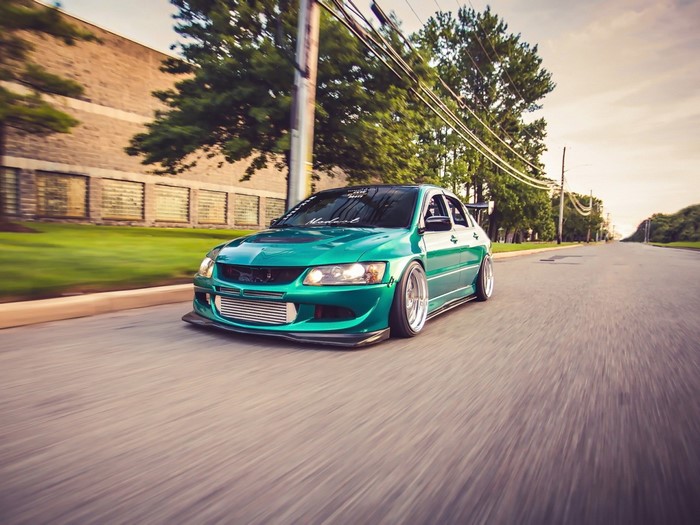 Green Mitsubishi Lancer Evolution VIII on a Street