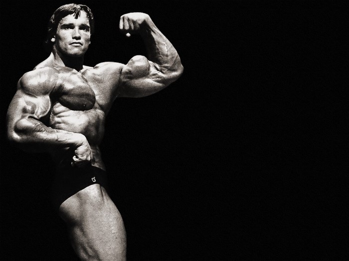 Arnold Schwarzenegger flexing muscles