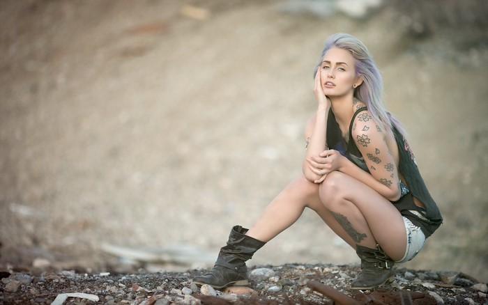 Woman with purple dyed hair and tattoos