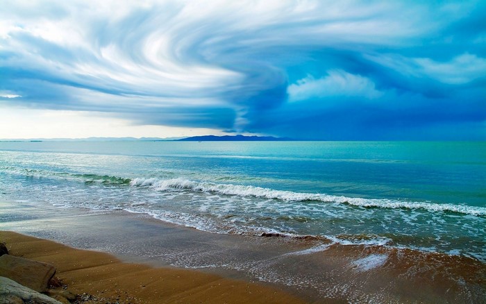 Beach with stormy sky and waves