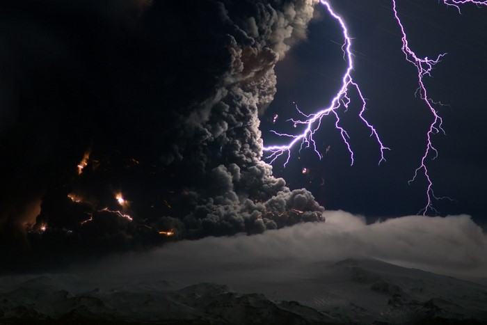Volcanic eruption with lightning at night