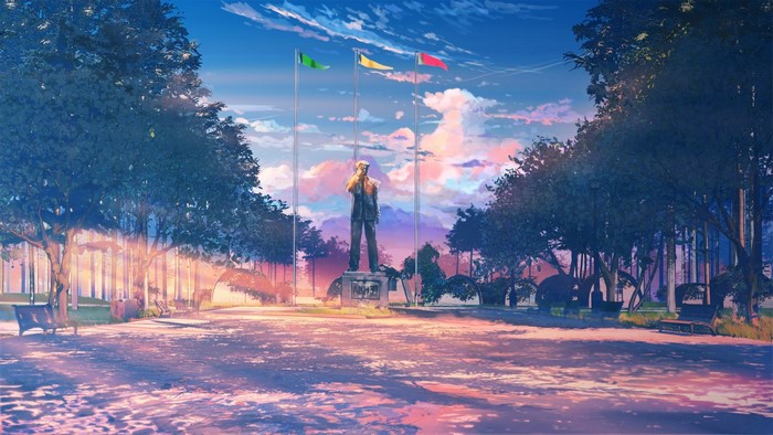 Statue with flags in a park at sunset