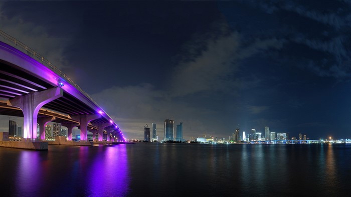 Miami Beach cityscape at night with illuminated bridge