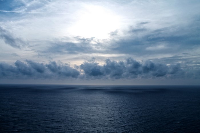 Dark ocean under cloudy sky