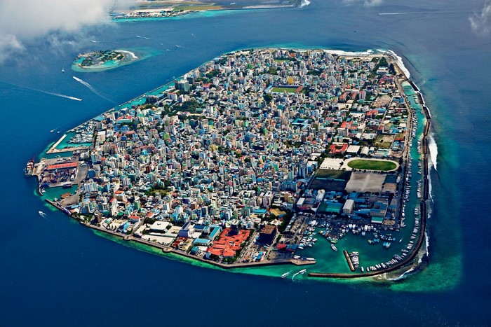 Aerial view of Male, Maldives city island with harbor and boats