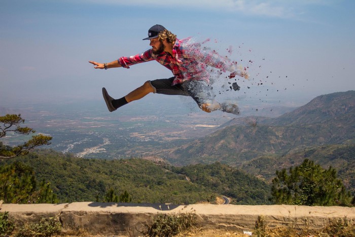 Man jumping over mountains with dissolving effect