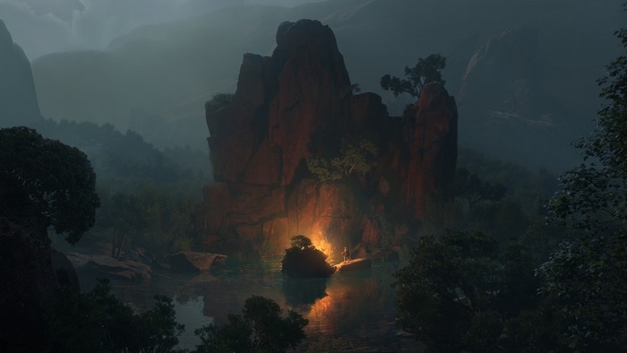 Campfire by a rocky lake at dusk