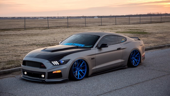Ford Mustang with blue rims and matte grey finish