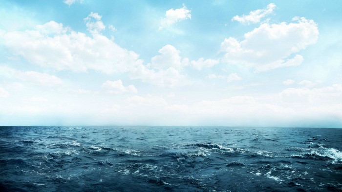 Ocean waves under a cloudy sky