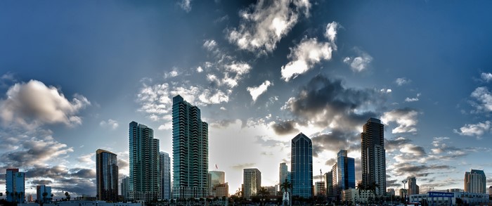 City skyline with skyscrapers and clouds