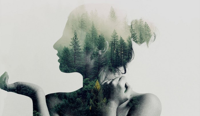 Double exposure of woman and forest