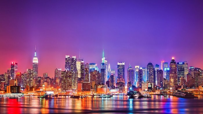 New York City skyline at night with colorful lights