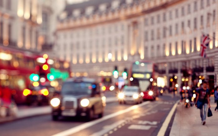 Blurred London street with traffic and buildings