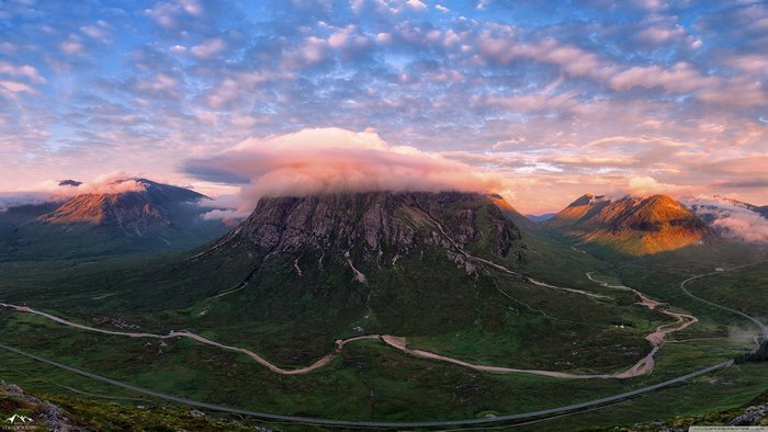 Scottish Highlands mountain pass with clouds at sunrise