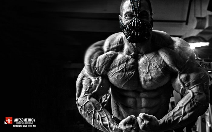 Bodybuilder wearing Bane mask flexing muscles