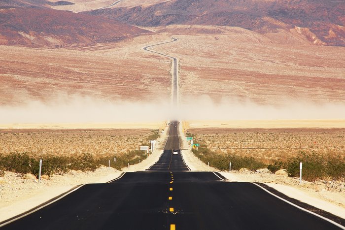 Desert road in Death Valley with dust storm