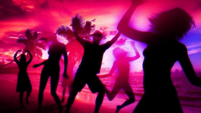 Silhouettes dancing on a beach at sunset