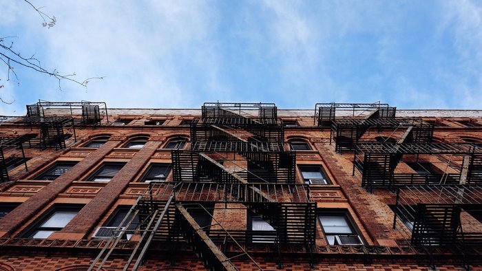 Old brick building with fire escapes in New York City