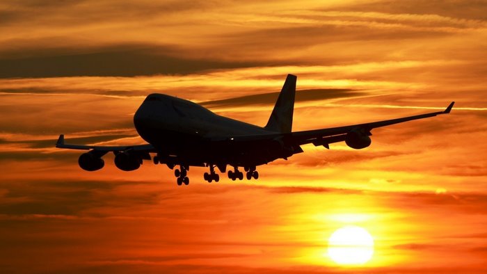 Boeing 747 airplane landing during sunset