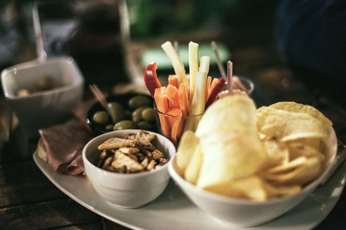 Appetizer platter with chips, olives, and vegetables