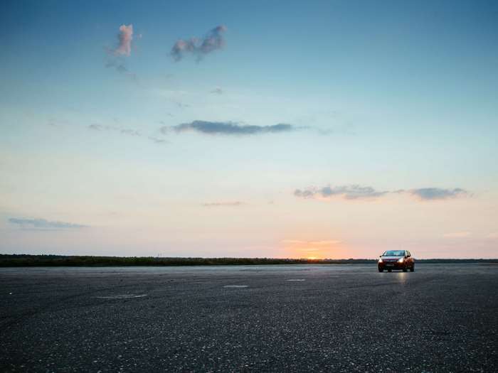 Car on Tarmac at Sunset